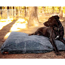 Load image into Gallery viewer, Black Labrador on a grey waxed canvas large dog bed outside in a park
