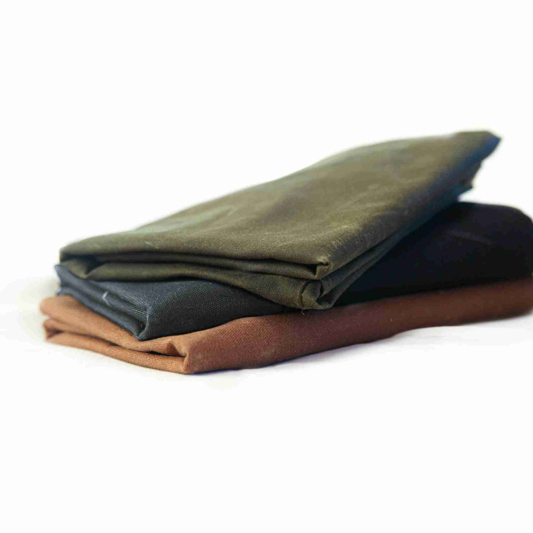 Fireside Hound waxed canvas dog bed covers folded on a white background